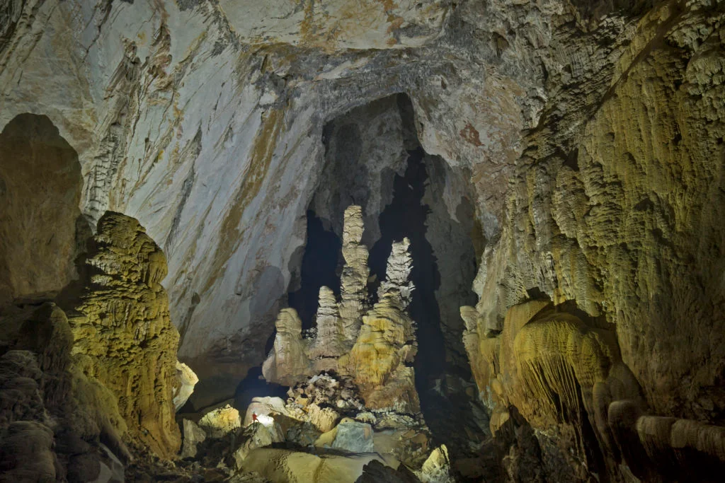 Figure 1: Sơn Đoòng cave passage. Note the scale of the person on the bottom left of the image. Photo Credit:Dave Bunnell CC BY-SA 4.0
